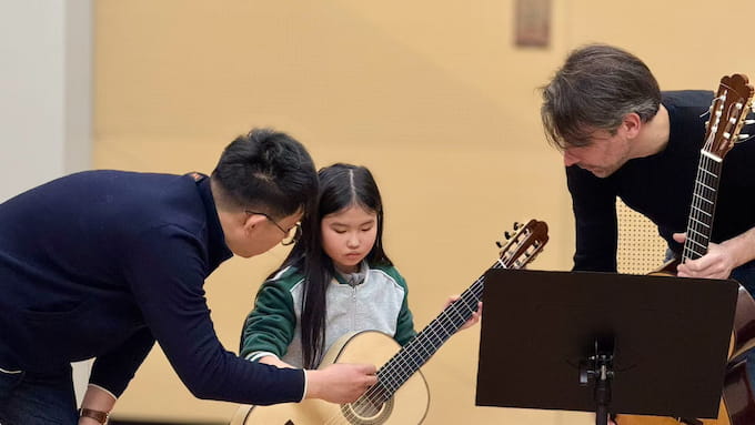 杰雷米在课堂给学生进行古典吉他演奏指导